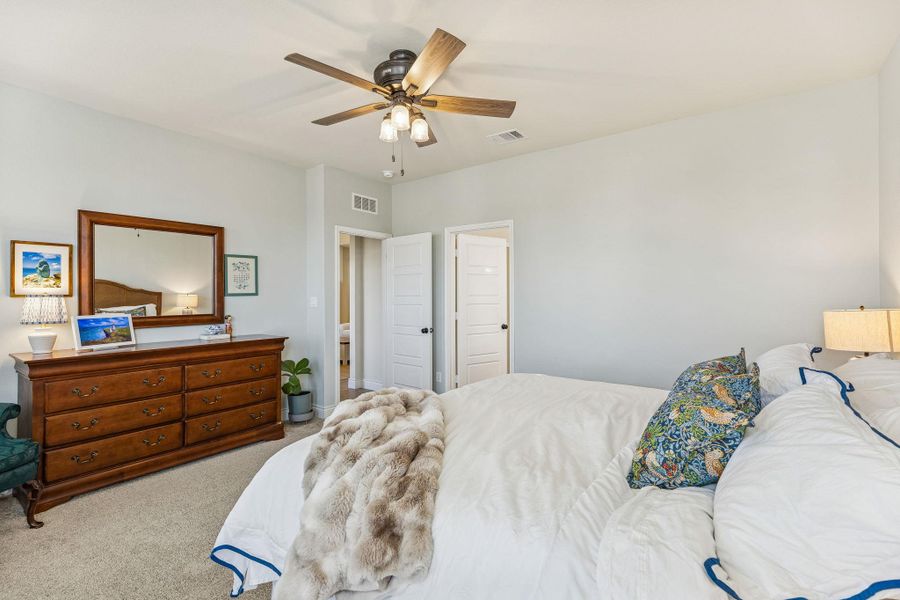 Priming bedroom on the main level set towards the back of the home