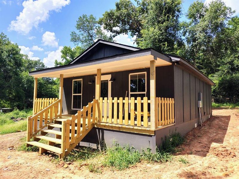 View of front of property featuring covered porch and board and batten siding