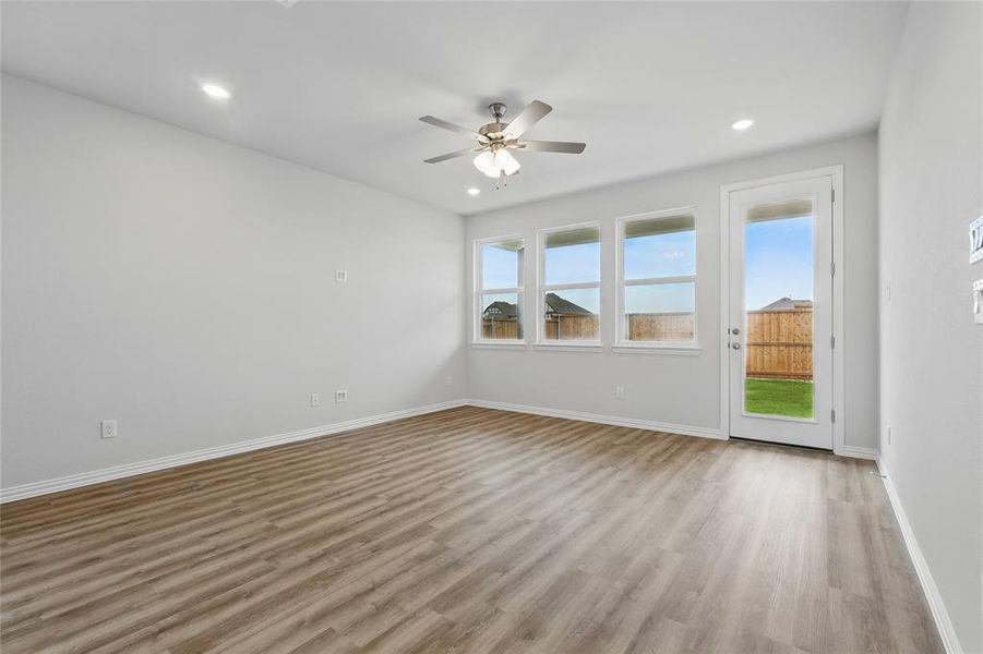 Empty room featuring a ceiling fan, light wood finished floors, and recessed lighting Empty room featuring a ceiling fan, light wood finished floors, and recessed lighting