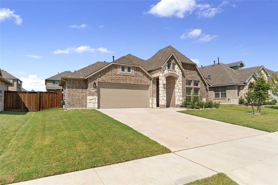 French provincial home with brick siding, concrete driveway, and a garage French provincial home with brick siding, concrete driveway, and a garage