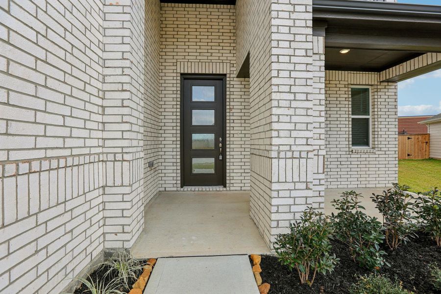 The large front porch is welcoming, spacious and comfortable - offering a functional space for relaxation or greeting neighbors.