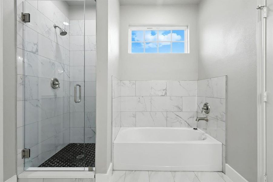 Bathroom featuring a shower stall and a garden tub Bathroom featuring a shower stall and a garden tub