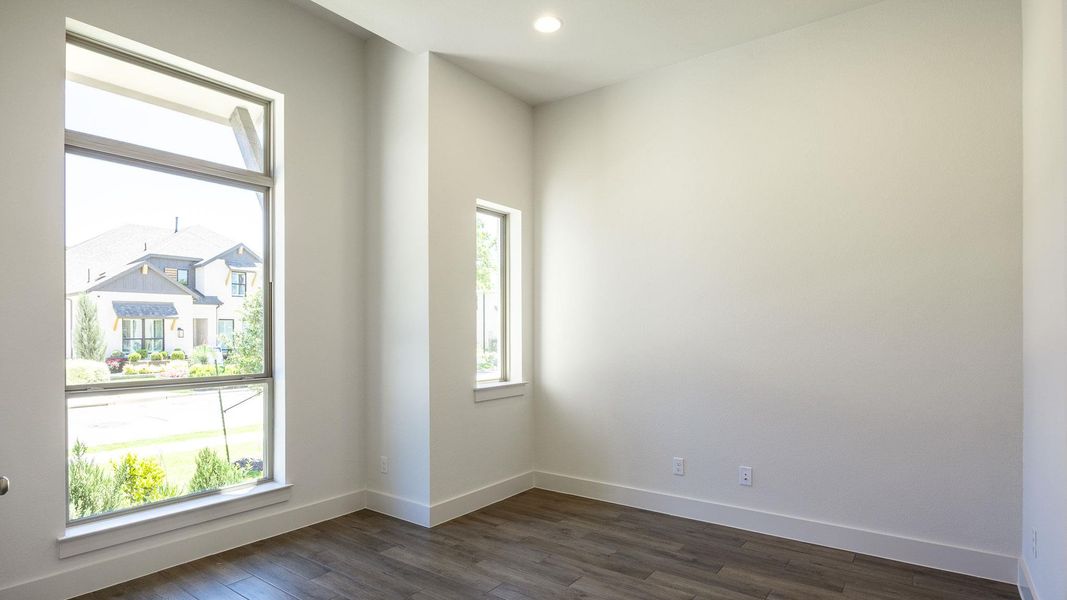 Unfurnished room featuring recessed lighting, baseboards, and dark wood-style flooring Unfurnished room featuring recessed lighting, baseboards, and dark wood-style flooring