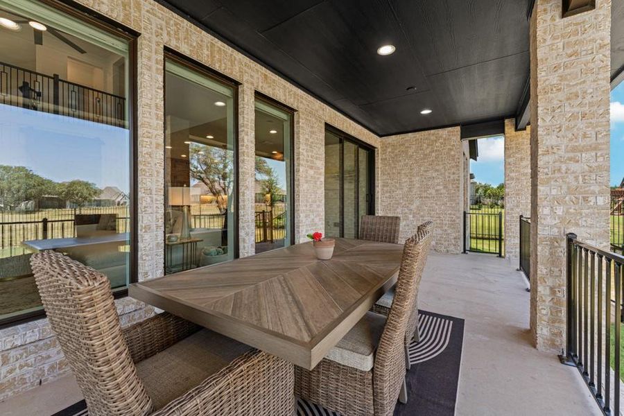 An inviting covered patio offers a comfortable dining space for alfresco enjoyment. An inviting covered patio offers a comfortable dining space for alfresco enjoyment.