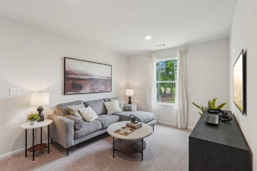 A living room with a couch and a coffee table. A living room with a couch and a coffee table.