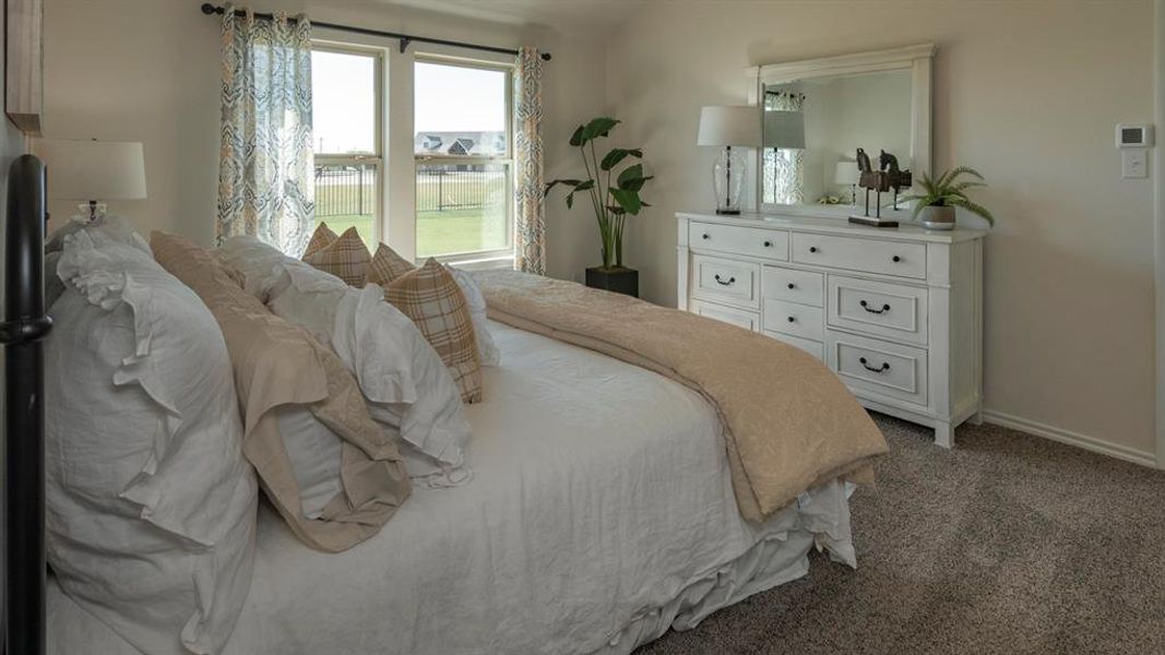 Bedroom featuring carpet floors and baseboards