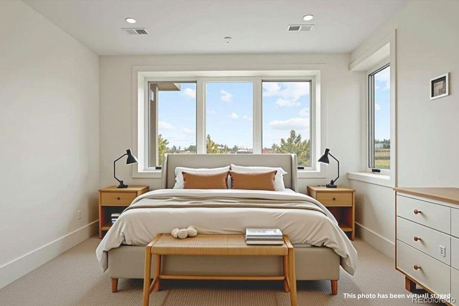 Lower-level bedroom (bedroom 3) with en suite bath. *This photo has been virtually staged.