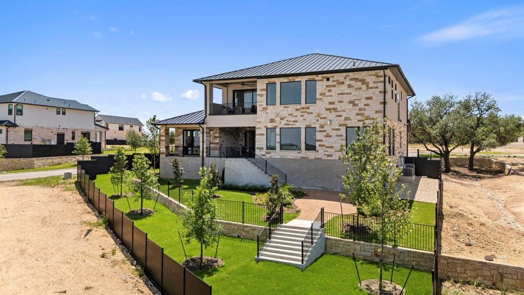 Exterior details and patio area of a home in Milky Way at River Place, Austin (Image 26).