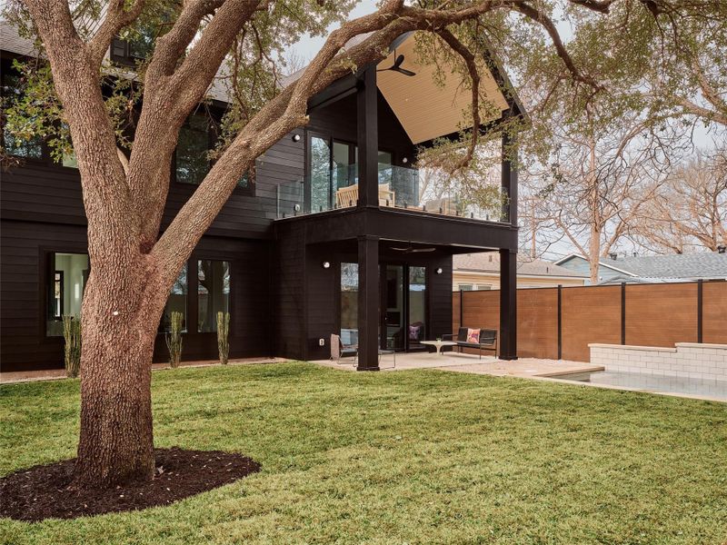 Rear view of house with a balcony and a patio area