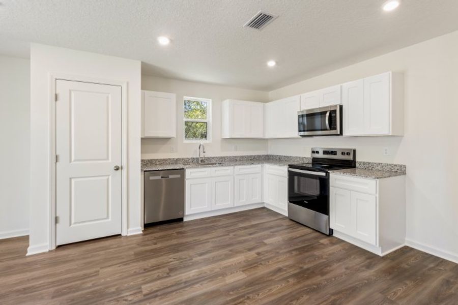 A kitchen with white cabinets. A kitchen with white cabinets.