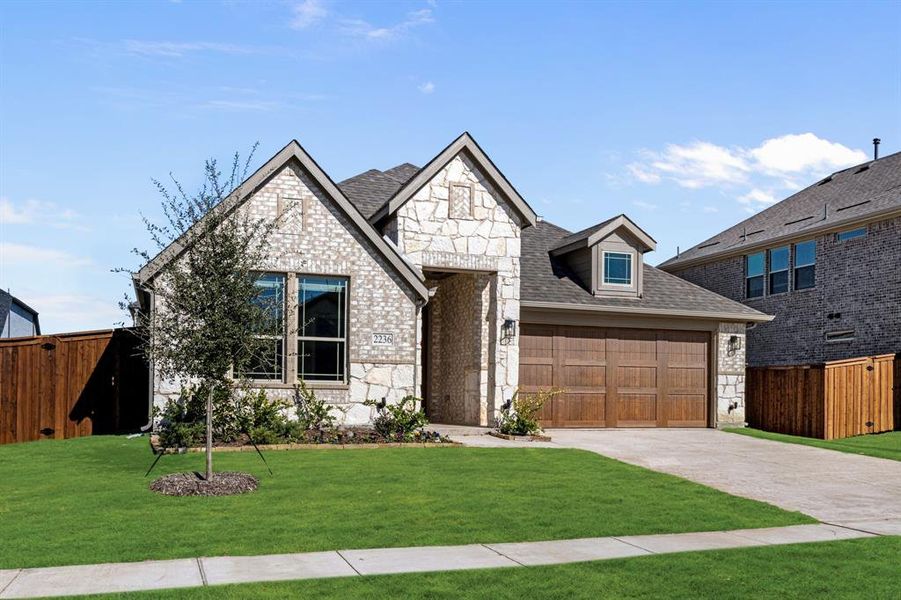 Front exterior of a new home in Sonoma Verde, McLendon-Chisholm, TX, highlighting curb appeal (Image 1).