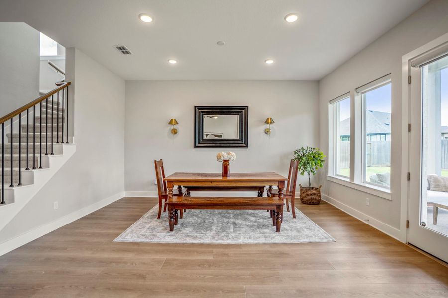 Open to the kitchen and family room, this bright dining area is ready for everything from lavish dinner parties to Wednesday night lasagna, with plenty of space to gather and linger long after dessert is served.
