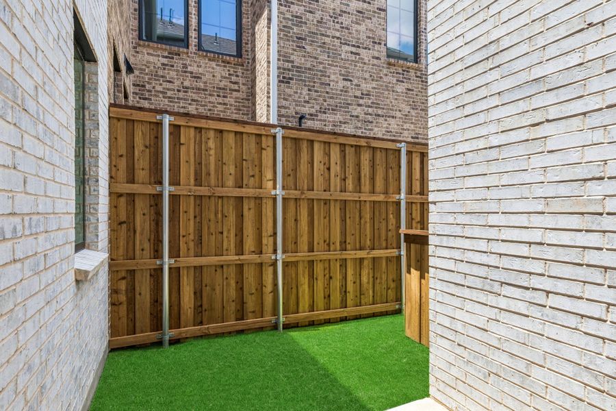 Exterior details and patio area of a home in Newman Village Townhomes, Frisco (Image 3). Exterior details and patio area of a home in Newman Village Townhomes, Frisco (Image 3).