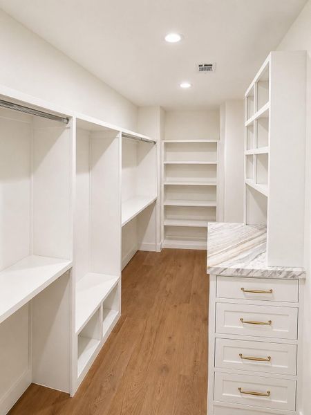Walk in closet with marble toped storage island