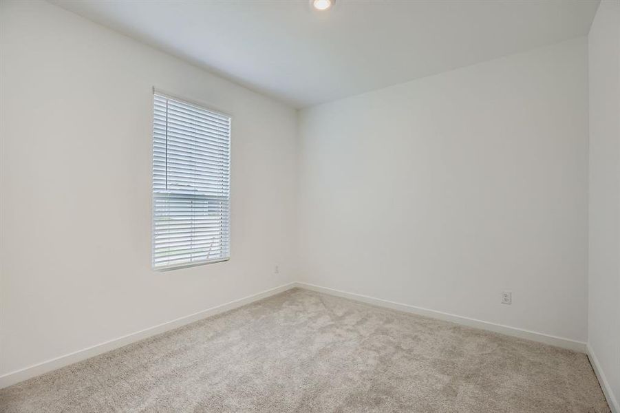 Carpeted empty room with baseboards and recessed lighting