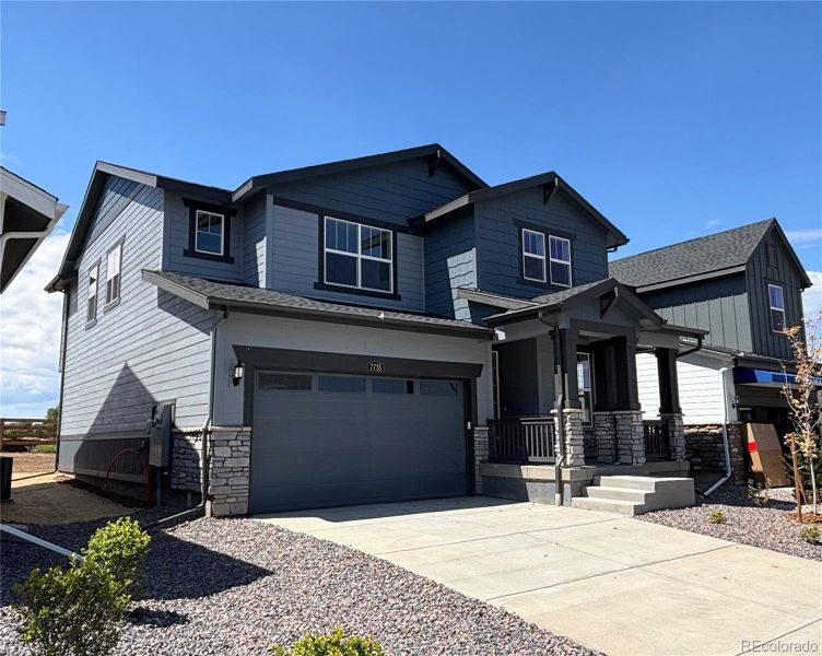 Front exterior of a new home in Vermilion Creek: The Pioneer Collection, Centennial, CO, highlighting curb appeal (Image 12).