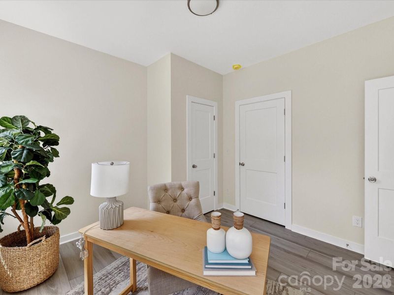 Versatile secondary bedroom offers the perfect space for a private home office or comfortable guest retreat, with ample natural light and a functional layout.