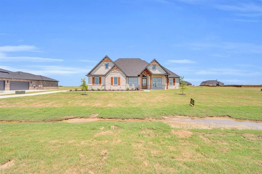 Craftsman-style home featuring a front lawn