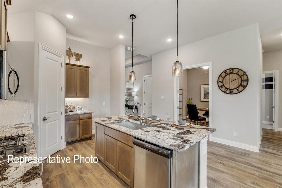 The property features a kitchen with a large island, granite countertops, and stainless steel appliances