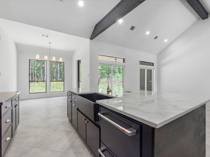 Enjoy this moody kitchen with two tone countertops that complement each other so well!