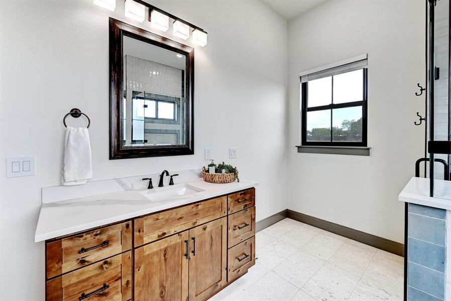 Bathroom featuring vanity and baseboards