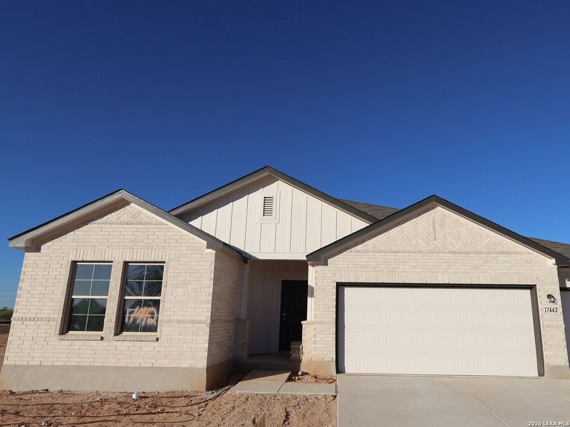 Front exterior of a new home in Hickory Ridge, Elmendorf, TX, highlighting curb appeal (Image 20). Front exterior of a new home in Hickory Ridge, Elmendorf, TX, highlighting curb appeal (Image 20).