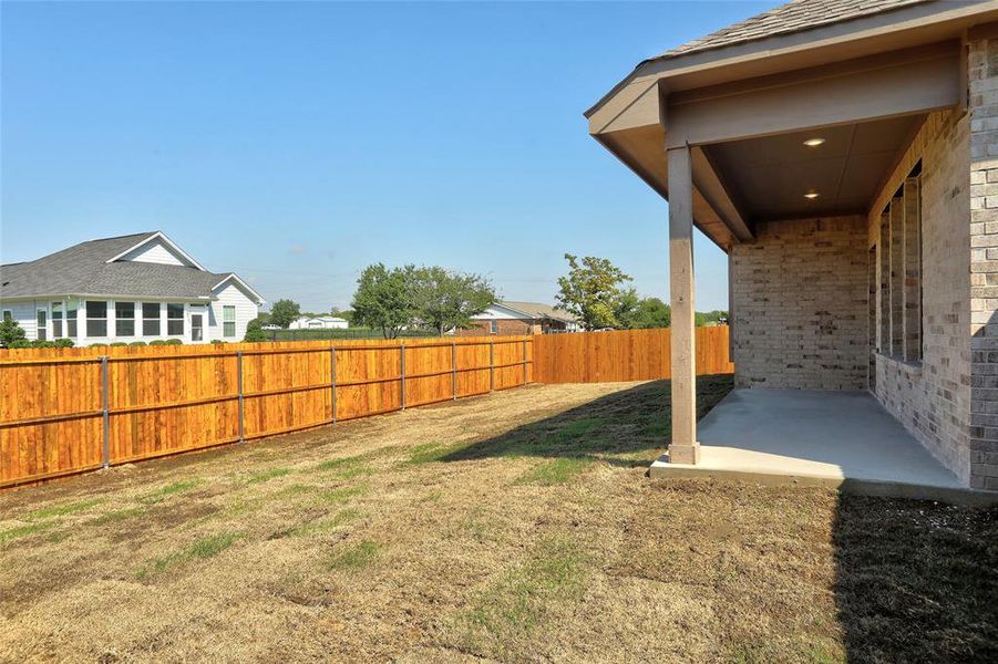 Fenced backyard featuring a patio Fenced backyard featuring a patio