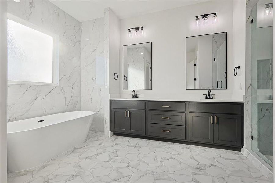 Bathroom featuring vanity, shower with separate bathtub, and tile walls