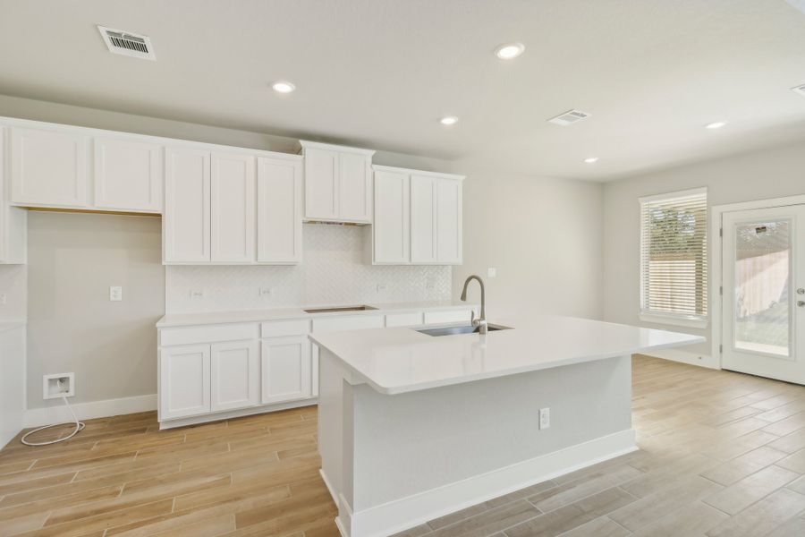 Kitchen in the Cedar floorplan at a Meritage Homes community.