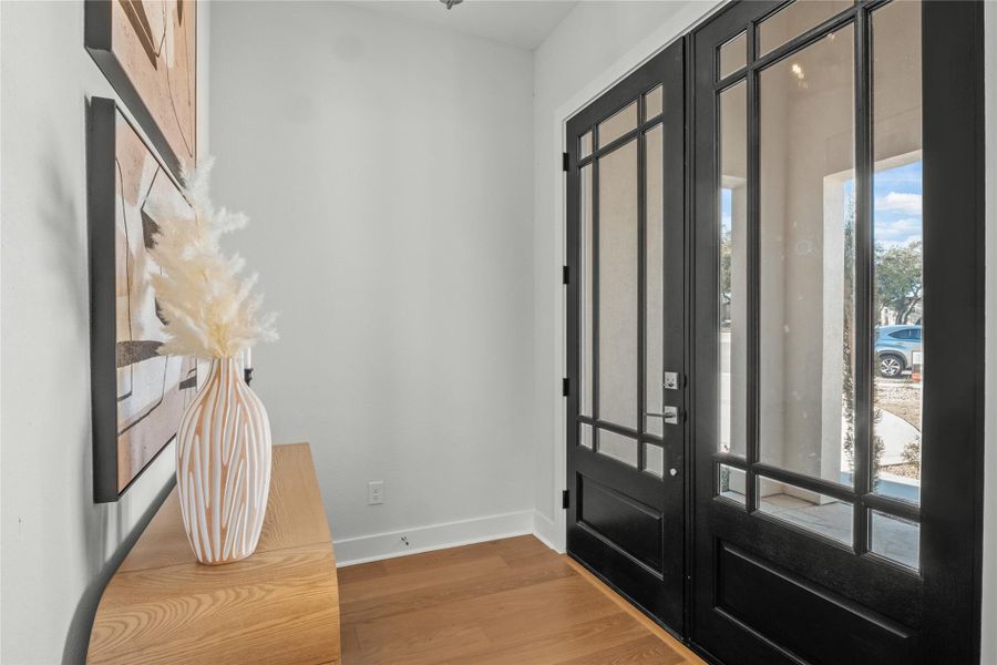Foyer entrance featuring baseboards and wood finished floors Foyer entrance featuring baseboards and wood finished floors