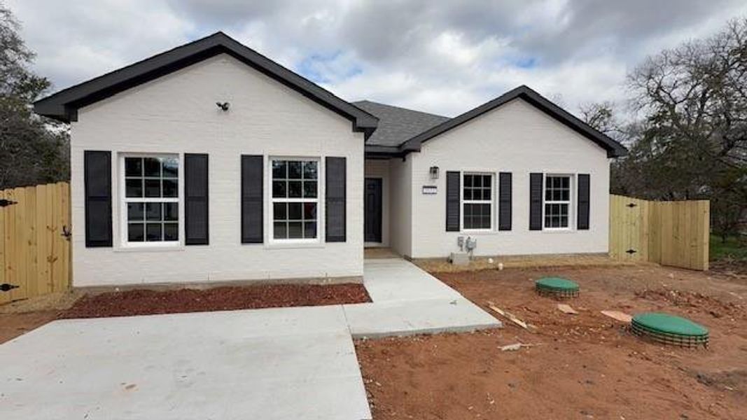 Ranch-style home featuring fence