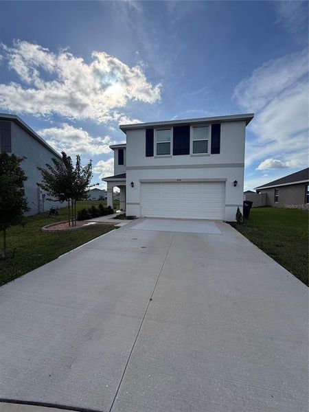 Front exterior of a new home in Evergreen, Bradenton, FL, highlighting curb appeal (Image 2). Front exterior of a new home in Evergreen, Bradenton, FL, highlighting curb appeal (Image 2).