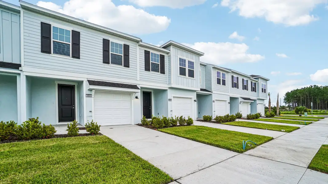 Front exterior of a new home in Twin Oaks, Zephyrhills, FL, highlighting curb appeal (Image 2). Front exterior of a new home in Twin Oaks, Zephyrhills, FL, highlighting curb appeal (Image 2).