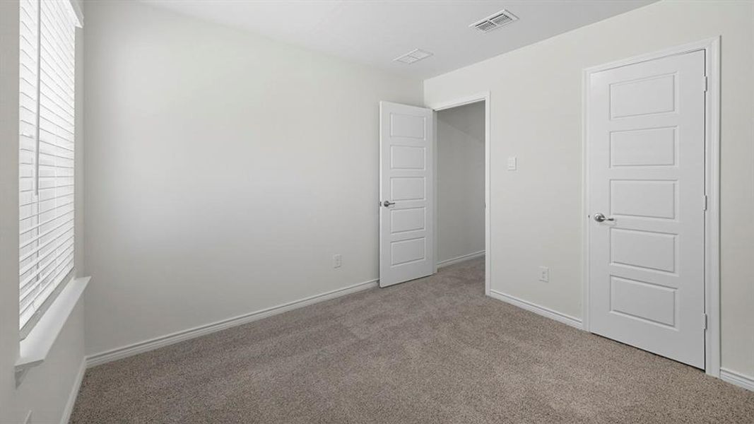 Unfurnished bedroom featuring carpet and baseboards