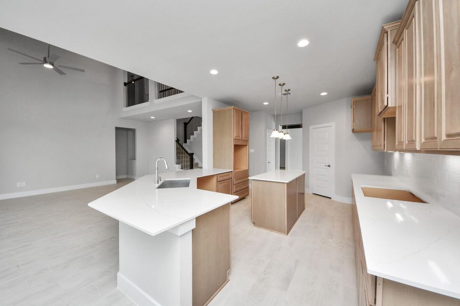 The open concept effortlessly connects the kitchen to the expansive family room, forming a perfect hub for gatherings. This seamless flow creates an inviting space where cooking and socializing come together harmoniously.