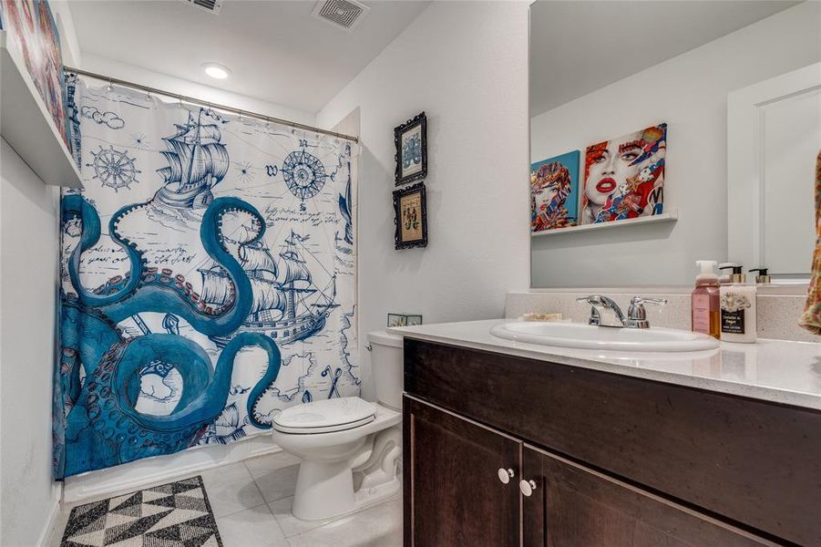 Full bathroom #2 with vanity, toilet, shower / bathtub combination with curtain, and tile patterned floors