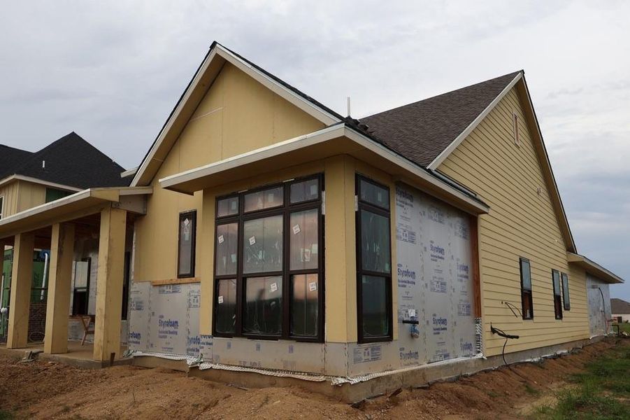 Front exterior of a new home in Riceland 50’ Alley Load Homesites, Mont Belvieu, TX, highlighting curb appeal (Image 1).