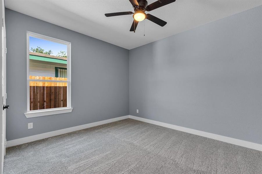 Unfurnished room featuring carpet and ceiling fan