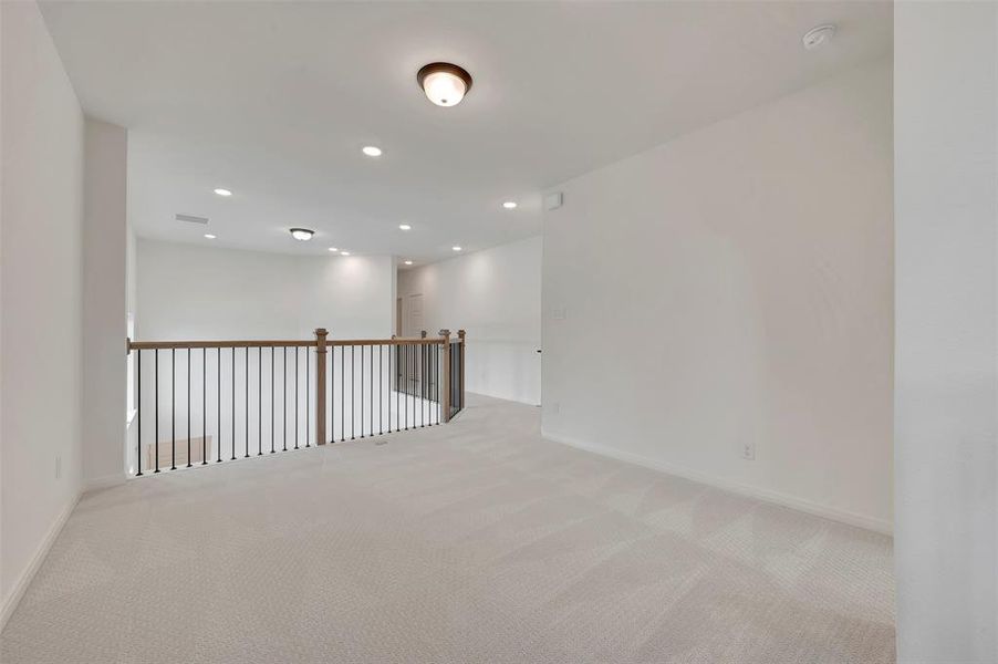 Spare room with light colored carpet and recessed lighting