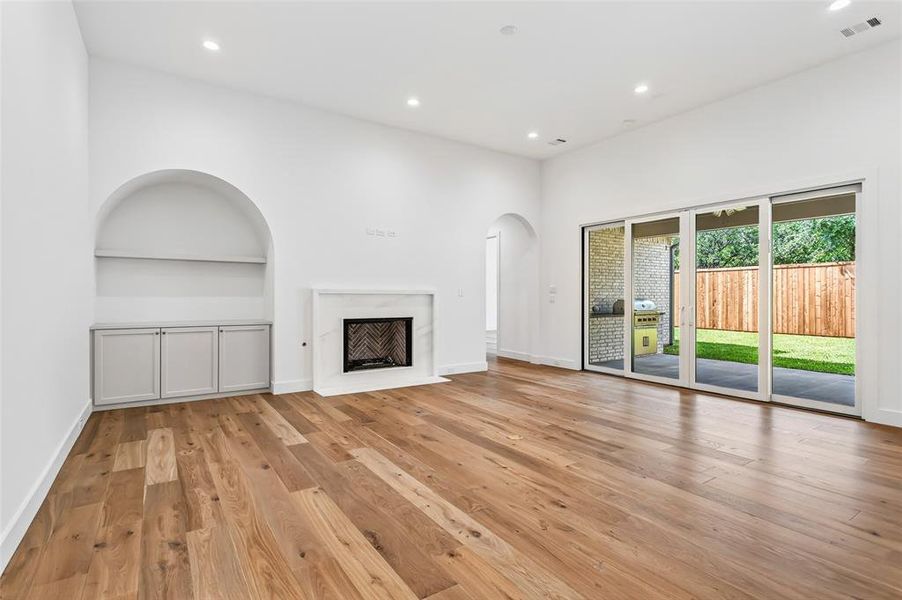 Built in custom cabinets & shelf in barrel arched nook