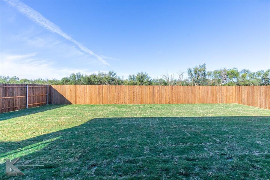 View of fenced backyard