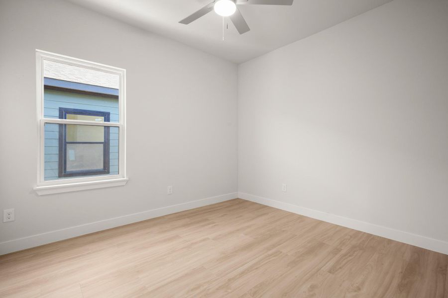 Spare room with light wood-style flooring and a ceiling fan