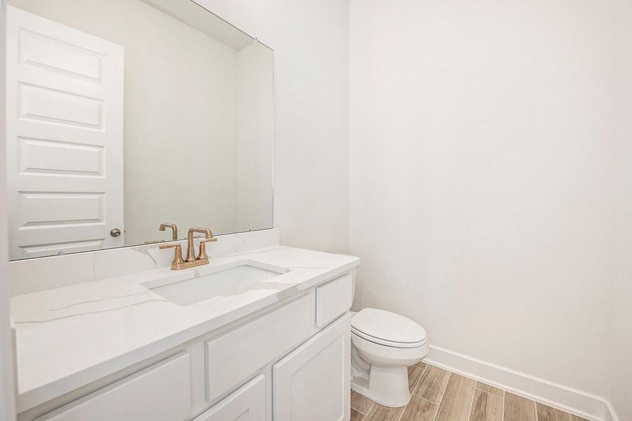 A secondary bedroom on the first floor provides flexibility for guests or multigenerational living.