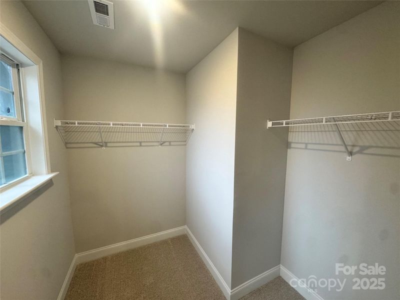 Primary walk in closet Primary walk in closet