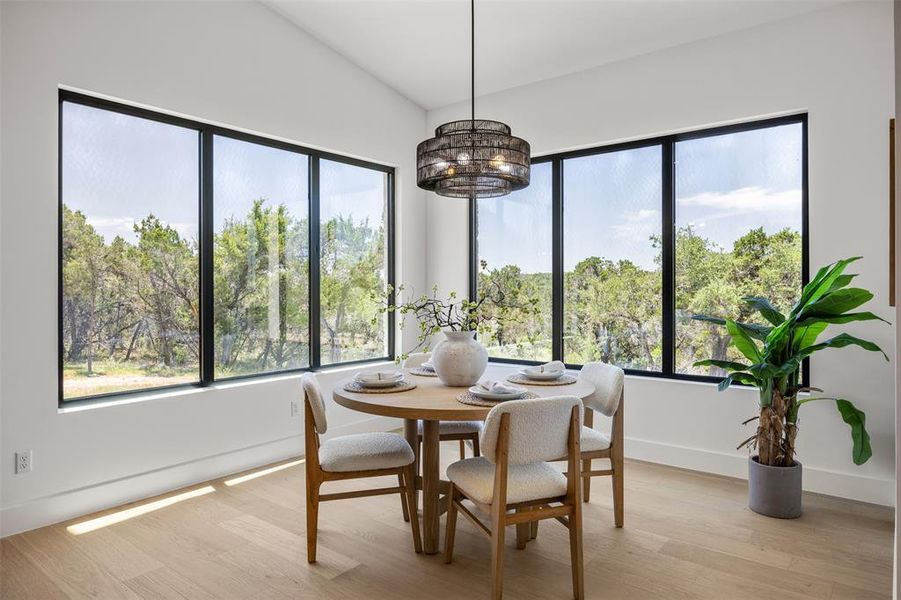 Panoramic windows offer inspiring views from this inviting dining area.