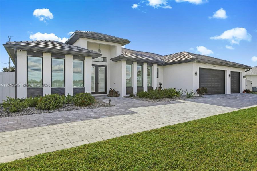 Front exterior of a new home in , Cape Coral, FL, highlighting curb appeal (Image 1). Front exterior of a new home in , Cape Coral, FL, highlighting curb appeal (Image 1).