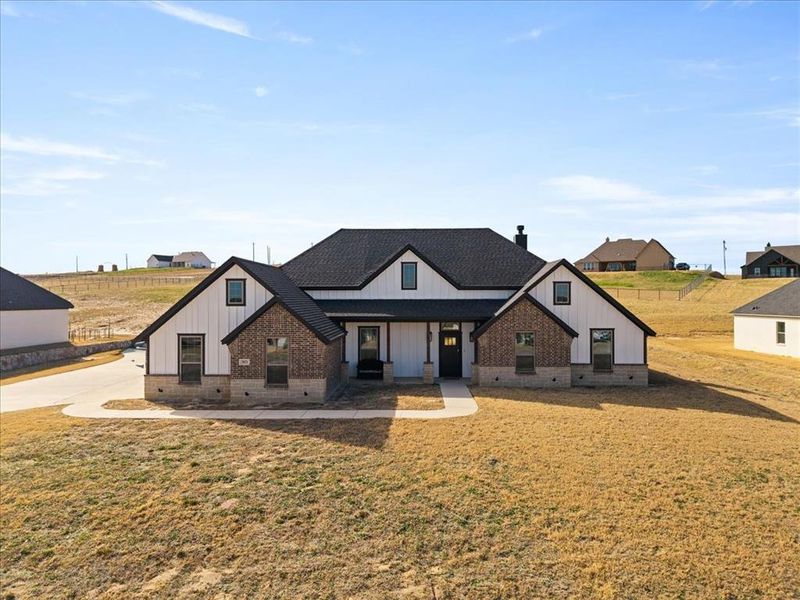 Front exterior of a new home in , Springtown, TX, highlighting curb appeal (Image 26).