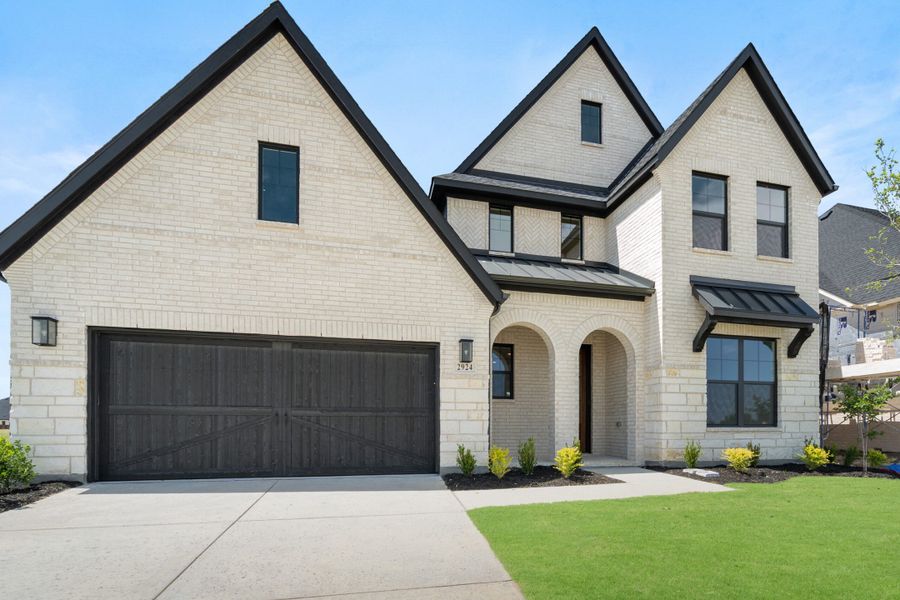 Front exterior of a new home in Cambridge Crossing, Celina, TX, highlighting curb appeal (Image 21). Front exterior of a new home in Cambridge Crossing, Celina, TX, highlighting curb appeal (Image 21).