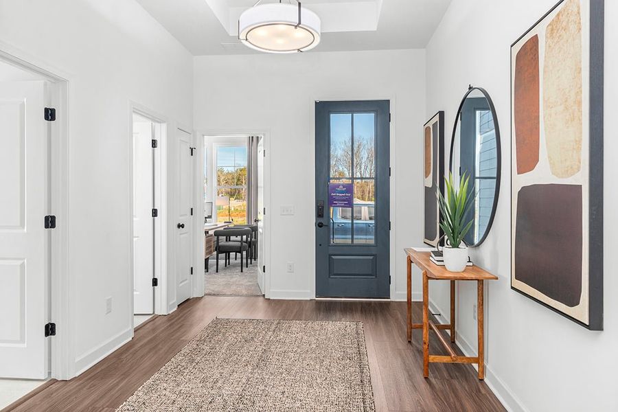 A room with white walls and a table with a plant on it.