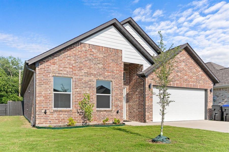 View of front of home featuring an attached garage, brick siding, and driveway View of front of home featuring an attached garage, brick siding, and driveway